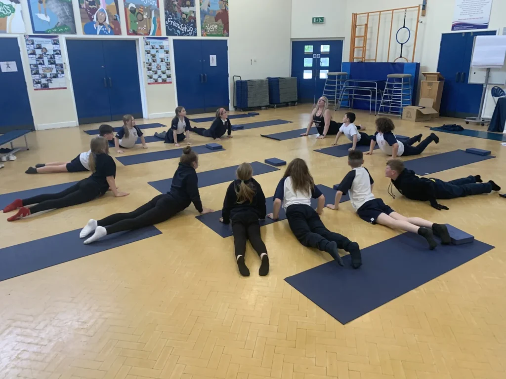 Classroom yoga session helping young people practise relaxation, grounding and self-awareness in Atherton schools