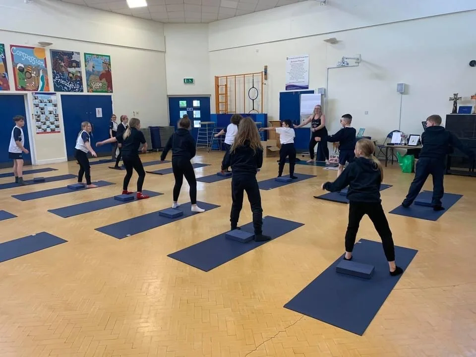Education-based yoga workshop introducing pupils to mindfulness, posture and breathing techniques in Bolton